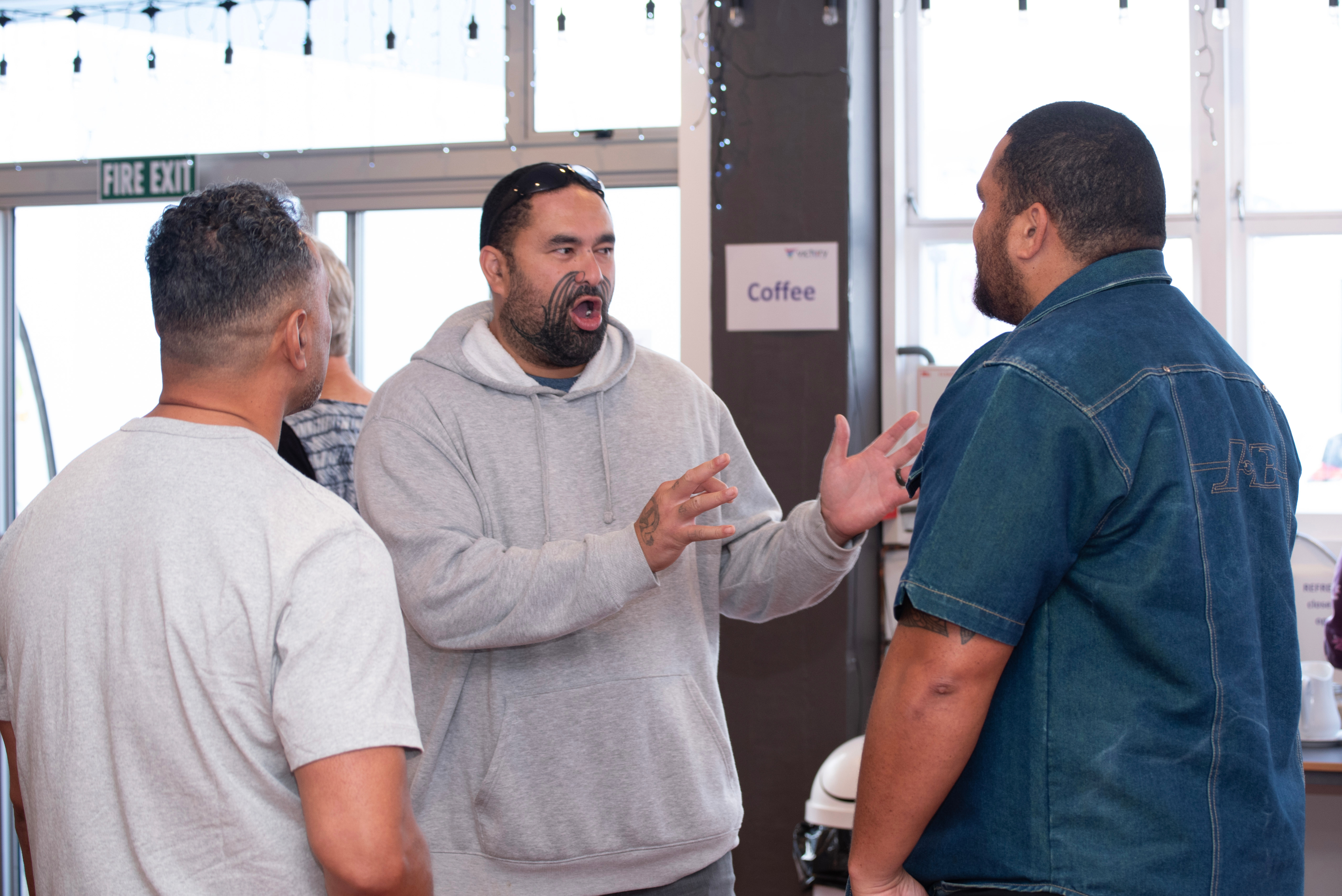 Man expressively talking to friends in church foyer