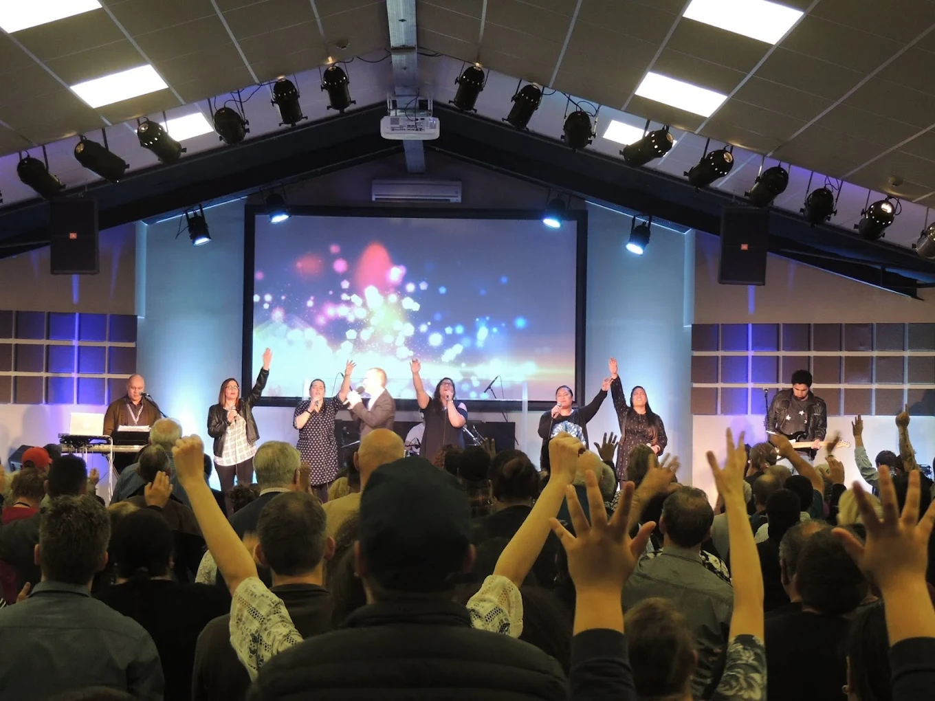 Congregation cheering and celebrating to sermon.