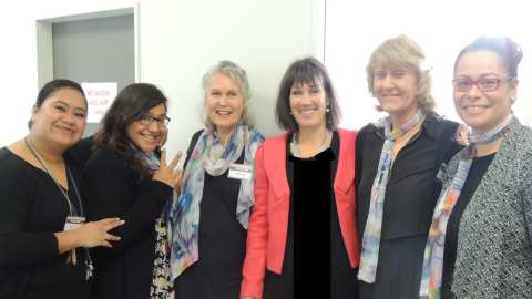 Row of women standing and smiling