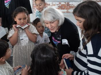 Elderly lady talking to group of children.
