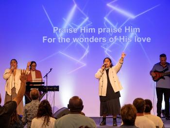 Worshipping while singing.